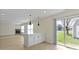 Bright open concept with an island counter overlooking the backyard and a fireplace in the living room at 7907 Oakdale Ln, Indianapolis, IN 46214