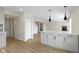 Open floor plan featuring island, modern lighting, and a fireplace with a stone surround at 7907 Oakdale Ln, Indianapolis, IN 46214