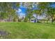 A backyard with mature trees, lush lawn, and storage shed, perfect for outdoor activities at 8049 Burn Ct, Indianapolis, IN 46217