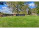 A beautiful fenced in backyard with large grassy area and mature trees at 8049 Burn Ct, Indianapolis, IN 46217