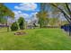 Backyard featuring a lush lawn, fire pit, storage shed, and privacy fence at 8049 Burn Ct, Indianapolis, IN 46217