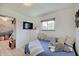 Cozy bedroom with a daybed, dresser with TV, and charming decor at 8049 Burn Ct, Indianapolis, IN 46217