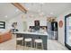 Modern kitchen with stainless steel appliances, island with seating, and wood beam at 8049 Burn Ct, Indianapolis, IN 46217
