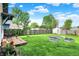 Lush backyard with metal garden beds, a deck, and well-maintained lawn at 844 N Emerson Ave, Indianapolis, IN 46219