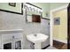 Classic bathroom with pedestal sink, tiled walls, and updated fixtures at 844 N Emerson Ave, Indianapolis, IN 46219