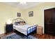 Cozy bedroom featuring wood floors, neutral walls, and comfortable furnishings at 844 N Emerson Ave, Indianapolis, IN 46219