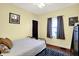 Bright bedroom with wood floors, neutral walls, and comfortable furnishings, ready for relaxation at 844 N Emerson Ave, Indianapolis, IN 46219