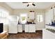 Bright kitchen with white appliances, ample natural light, and classic tile flooring at 844 N Emerson Ave, Indianapolis, IN 46219