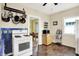 Functional kitchen with a gas range, hanging pot rack, and easy access to the dining area at 844 N Emerson Ave, Indianapolis, IN 46219
