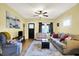 Spacious living room with hardwood floors, comfortable seating, and a large window for natural light at 844 N Emerson Ave, Indianapolis, IN 46219