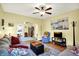 Bright living room with a ceiling fan, hardwood floors, cozy seating, and ample natural light at 844 N Emerson Ave, Indianapolis, IN 46219