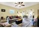 Open-concept living room with hardwood floors, comfortable seating, and seamless flow to the dining area at 844 N Emerson Ave, Indianapolis, IN 46219