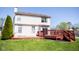 Two-story home with a large backyard, and an elevated wooden deck with stairs at 9718 Jupiter Pass, Carmel, IN 46032