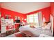 Cozy bedroom featuring bright red walls and plenty of natural light at 9718 Jupiter Pass, Carmel, IN 46032