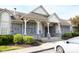 Community clubhouse with stone and siding featuring covered front entry and manicured landscaping at 9718 Jupiter Pass, Carmel, IN 46032
