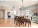 Open dining area flows into the kitchen, offering modern lighting and seamless living at 9718 Jupiter Pass, Carmel, IN 46032