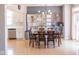 Open concept dining area leading to a modern kitchen with stainless steel appliances at 9718 Jupiter Pass, Carmel, IN 46032