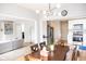 Open dining and kitchen area with modern lighting fixtures and hardwood floors at 9718 Jupiter Pass, Carmel, IN 46032