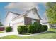 Exterior view of home featuring brick accents, a well-manicured lawn, and an attached two-car garage at 9718 Jupiter Pass, Carmel, IN 46032