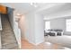 Welcoming foyer with staircase and an open view to the carpeted living room at 9718 Jupiter Pass, Carmel, IN 46032