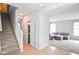 Open concept foyer leads to living area with staircase access to upper level at 9718 Jupiter Pass, Carmel, IN 46032
