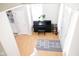Light-filled foyer showcasing hardwood floors, a piano, and ample space for a welcoming entry at 9718 Jupiter Pass, Carmel, IN 46032