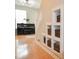 Hallway view with built in storage shelves under the stairs and a piano at 9718 Jupiter Pass, Carmel, IN 46032