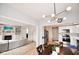 Open-concept living room with a fireplace and built-in shelving, connecting to a modern kitchen and dining area at 9718 Jupiter Pass, Carmel, IN 46032