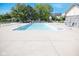 Outdoor community pool with many chairs surrounded by mature trees and a blue sky at 9718 Jupiter Pass, Carmel, IN 46032
