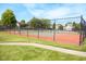 Outdoor tennis court surrounded by lush trees in the community at 9718 Jupiter Pass, Carmel, IN 46032