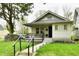Inviting single-story home features a cozy front porch with ample seating at 1014 W 32Nd St, Indianapolis, IN 46208