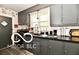 Efficient kitchen with dark cabinets and countertops at 1014 W 32Nd St, Indianapolis, IN 46208
