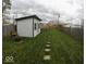 A lush backyard features manicured lawn with stepping stones leading up to a shed at 1035 Albany St, Indianapolis, IN 46203