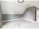 This attic bedroom offers neutral walls, carpeted floors, and barn-style door at 1035 Albany St, Indianapolis, IN 46203
