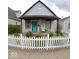 Charming home with a welcoming porch and a well-maintained, inviting white picket fence at 1035 Albany St, Indianapolis, IN 46203