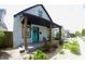 Charming two-story home with a welcoming front porch, colorful door, and nicely landscaped front yard at 1035 Albany St, Indianapolis, IN 46203
