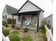 Inviting house with covered front porch, stylish chairs, and lush landscaping in a nicely designed space at 1035 Albany St, Indianapolis, IN 46203