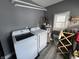 This laundry room features a modern washer and dryer, plus a water heater and window at 1035 Albany St, Indianapolis, IN 46203