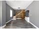 Open-concept living space features hardwood floors, modern paint, and a stylish staircase at 1035 Albany St, Indianapolis, IN 46203