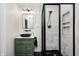 Bright bathroom features a black framed shower, green vanity, and marble-look tile at 10805 Charlemagne Dr, Indianapolis, IN 46259