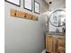 Neutral toned half bathroom featuring wood accents and a circular mirror at 10805 Charlemagne Dr, Indianapolis, IN 46259