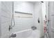 White tiled bathtub shower combination with built in niche for storage at 10805 Charlemagne Dr, Indianapolis, IN 46259