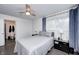 Bright bedroom features hardwood floors, a ceiling fan, a bedside table and an ensuite bathroom at 10805 Charlemagne Dr, Indianapolis, IN 46259
