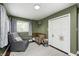 Green toned Bedroom features a crib, plush chair, and decor at 10805 Charlemagne Dr, Indianapolis, IN 46259