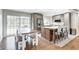 Spacious kitchen with an island and grey cabinets, an eating area, and outdoor patio view through sliding doors at 10805 Charlemagne Dr, Indianapolis, IN 46259