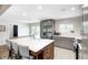 Bright, open kitchen featuring an island with seating, stainless steel appliances, and sliding glass doors at 10805 Charlemagne Dr, Indianapolis, IN 46259