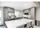 Modern kitchen with gray cabinetry, stainless steel appliances, and a spacious island with seating at 10805 Charlemagne Dr, Indianapolis, IN 46259