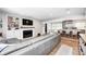 Open concept living room showcasing a fireplace, built-in shelving, and seamless flow into the kitchen area at 10805 Charlemagne Dr, Indianapolis, IN 46259