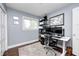 Cozy home office with a modern desk setup, a large window, and a decorative rug over hardwood floors at 10805 Charlemagne Dr, Indianapolis, IN 46259