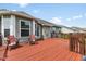 Spacious back deck with wood flooring and railings, ideal for outdoor seating and entertaining with comfortable wooden chairs at 1105 Wild Ridge Blvd, Brownsburg, IN 46112